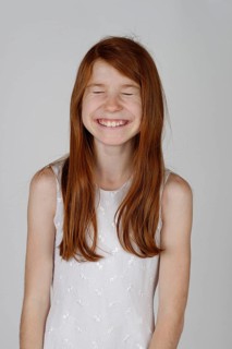 Girl laughing with her eyes closed