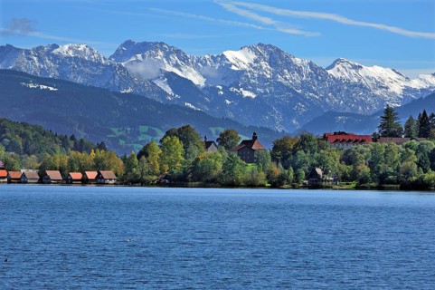 Snow-covered Oberstdorf Mountains behind Buhl am Alpsee with Alpsee lake