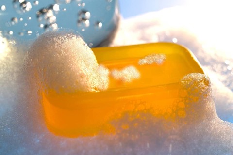 Bar of yellow glycerine soap with foam