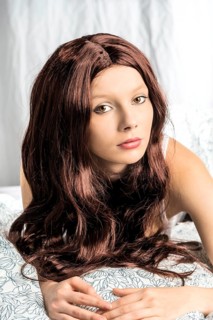Woman wearing a wig in bed