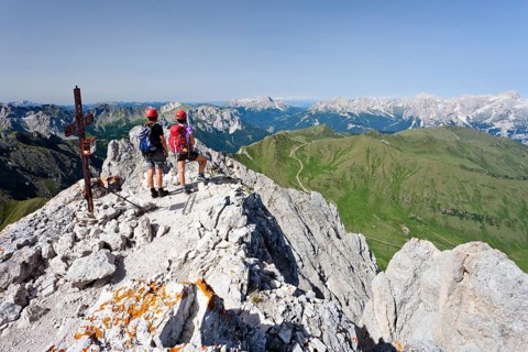 Climber on the summit of Colac on the Via Ferrata dei Finanzieri in Val di Fassa