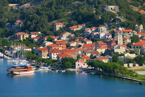 Townscape with sailing ship in the foreground