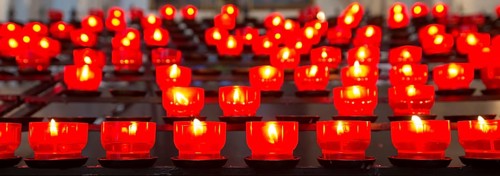 Burning votive candles in a church