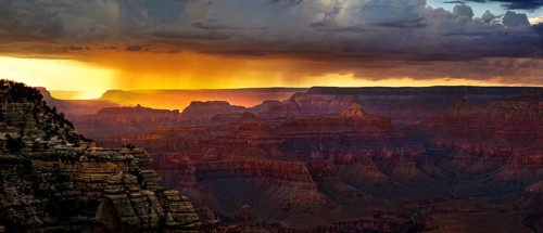 View of the Grand Canyon at sunset with storm clouds