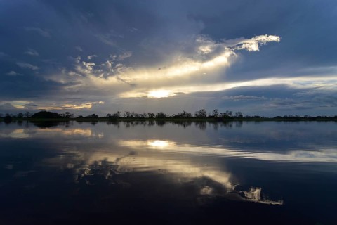 Dusk at a lake-like widened part of the Amazon or Rio Solimoes