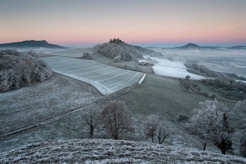 Hoar frost covered fields and meadows in Hegau with the Hohenstoffeln Mountain