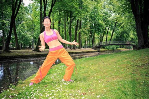 Woman dancing zumba in a park