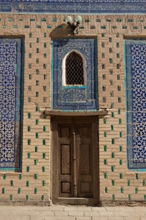 Door and mosaic-decorated wall