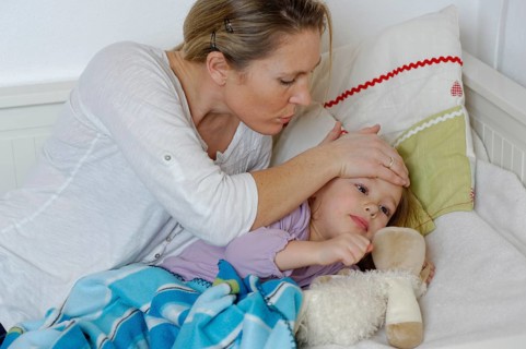 Mother taking care of her sick daughter