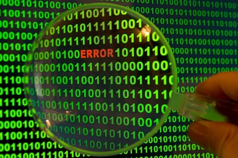 Binary code with the word 'Error' viewed through a magnifying glass