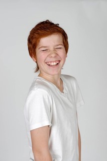Boy laughing with his eyes closed
