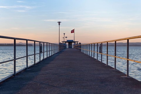 Railing of the ship pier of Mannenbach in the evening light