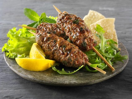 Kofte kebabs with salad and lemon wedges