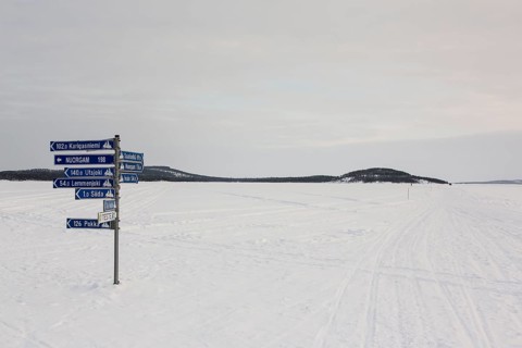 Sign post on frozen over Lake Inari