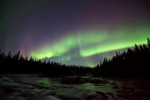 Northern lights or aurora borealis over river