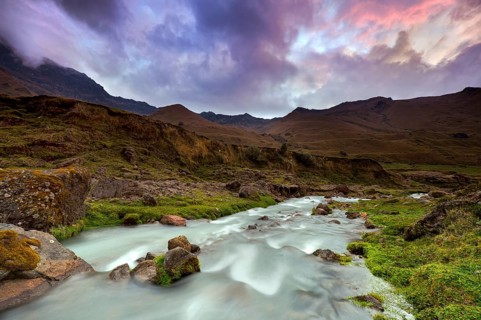Mountain stream with the peaks of El Altar or Kapak Urku