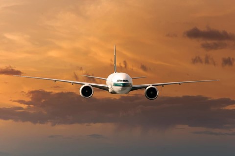 Cathay Pacific Boeing 777-367 ER in flight in the evening light