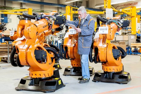 Employee of the robot manufacturer KUKA AG completing the shipping documents before delivery of KUKA robots