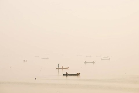 Fishermen in their boats in the morning light