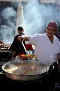 Cook boils vegetables in a large pan at the annual All Saints Market in Cocentaina