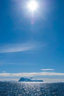 Sun shining over an iceberg