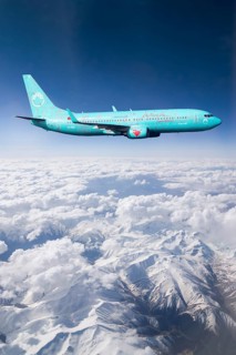 SunExpress Boeing 737 in flight over mountains
