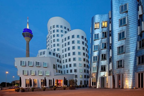 Rheinturm or Rhine Tower with two of the Gehry buildings at Neuer Zollhof