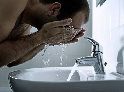 Man washing his face with both hands