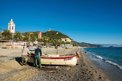 Fishermen with a fishing boat on the beach of Noli