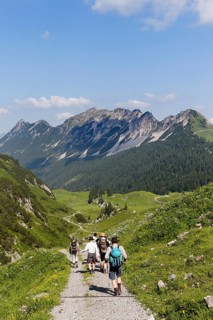 Hikers hiking above the Laguz Alps and Breithorn Mountain