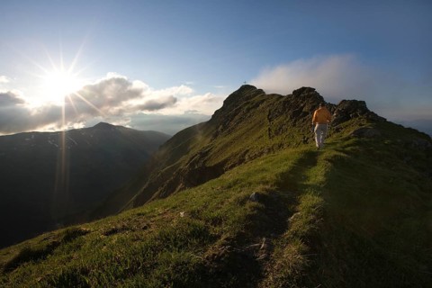 Hiker on the summit of Mt Grosser Galtenberg in the evening light