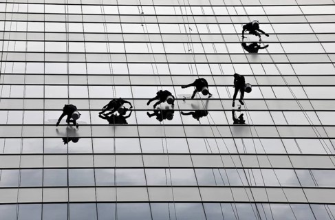 Window cleaners cleaning a glass facade