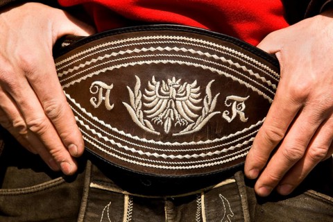 Man holding his traditional belt with both hands