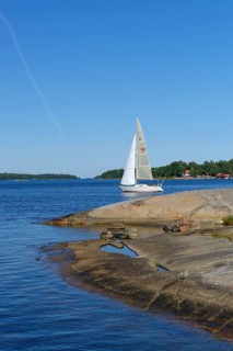Sailboat and typical round polished rocks