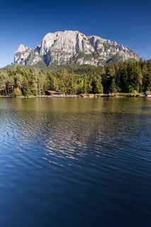 Lago di Fie lake in front of Sciliar Mountain