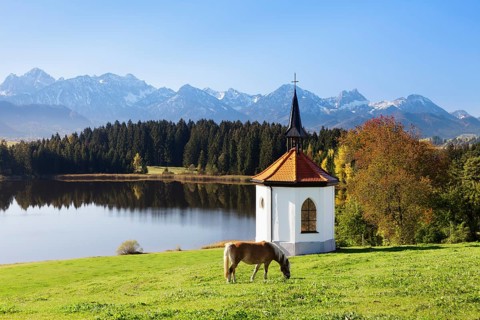 Chapel on Lake Hergratsried with Allgau Alps