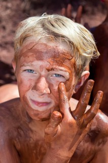 Boy applying healing earth