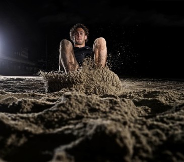 Athlete lands in the sand at the long jump