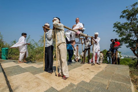 Porters carrying a Jain pilgrim up Mount Shatrunjaya