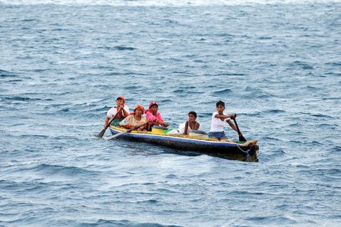 Kuna Indian women in a dugout canoe