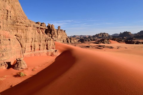 Eroded sandstone rocks and sand dunes at the Cirque