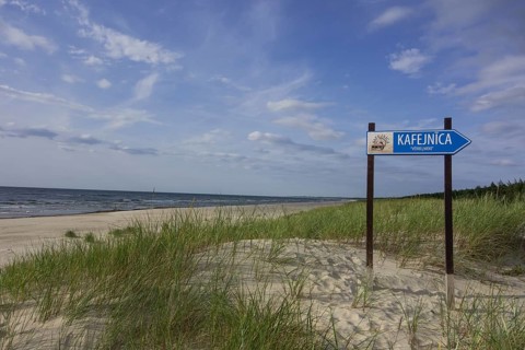 Sandy beach on the Baltic Sea with sign for a cafe