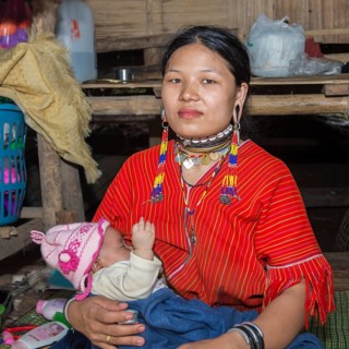 Long-necked woman with her baby