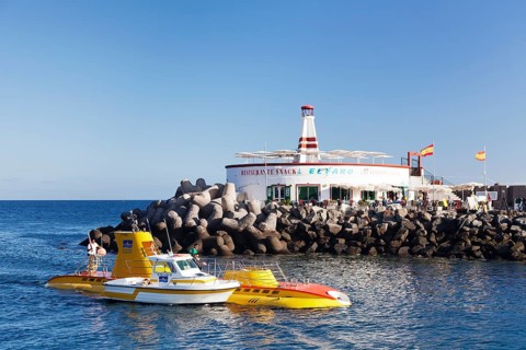 Submarine Yellow Submarine in front of lighthouse