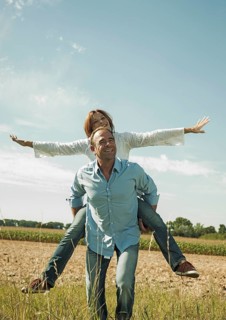 Man giving a woman a piggyback ride