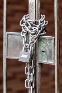 Chain with padlock on an iron gate