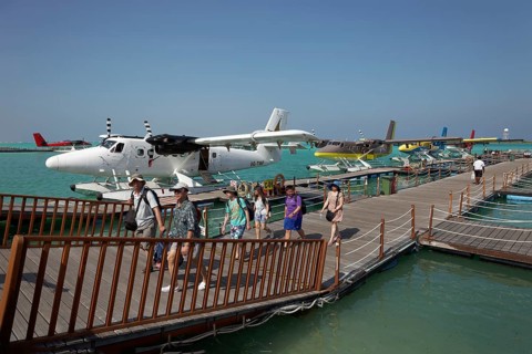 Tourists leaving the pontoon with hydroplanes moored