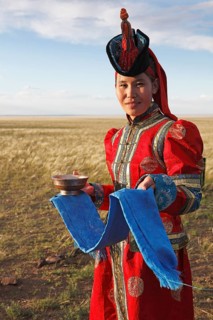 Woman in traditional dress with traditional welcome utensils