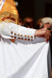 Woman in traditional costume taking part in a parade