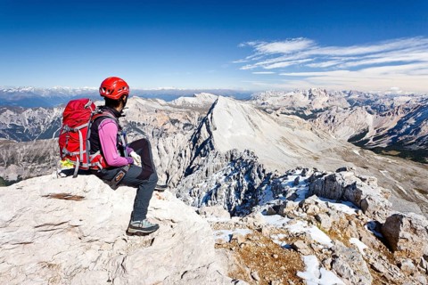 Mountain climber on the peak of Zehnerspitze Mountain in the Fanes Group